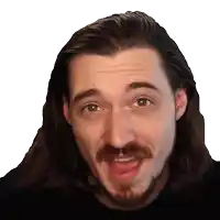 a man with long hair and a beard is smiling