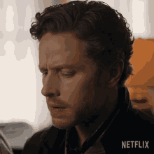 a close up of a man 's face with netflix written on the bottom right
