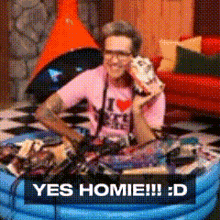 a man in a pink shirt talking on a phone with the words yes homie !!! : d below him