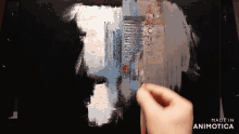 a person is painting on a canvas with the words made in animotica in the corner