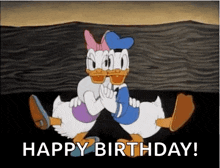 donald duck and daisy duck are hugging each other in a happy birthday greeting .