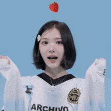 a girl wearing a white sweater with the word rchino on the front