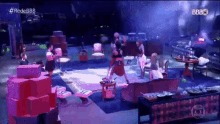 a group of people are gathered in a room with the letters bbb on the bottom left