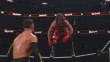 two men are wrestling in a ring with a sign on the wall that says prime