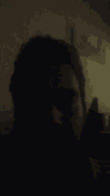 a man 's face is shown in the dark with his eyes closed
