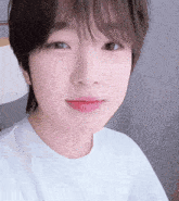 a close up of a person 's face with a lamp in the background