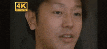 a close up of a man 's face with a 4k ultrahd logo on the bottom