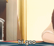 a person sitting on a table with the word hi geo on it