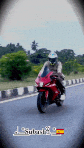 a man riding a red motorcycle with the name subash on the bottom right