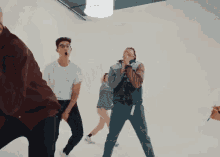 a group of young men are dancing together in a studio .