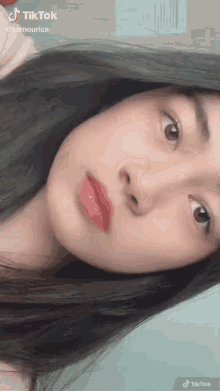 a close up of a girl 's face with a tiktok watermark on it