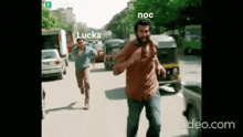 two men are running down a street with lucka written on the bottom of the screen