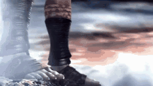 a close up of a person 's foot wearing a pair of sandals