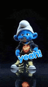 a smurf is dancing in front of a black background and says yeah !