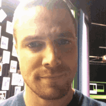 a close up of a man 's face with a beard and blue eyes
