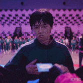 a man is holding a card that says netflix