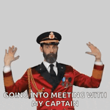 a man with a beard is wearing a red suit and tie and going into a meeting with his captain .