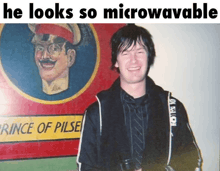 a man stands in front of a painting of a man with the caption he looks so microwavable