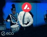 a man in a marching band is playing drums with a red triangle in front of his face