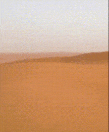 a desert landscape with a grid pattern and a blue sky in the background
