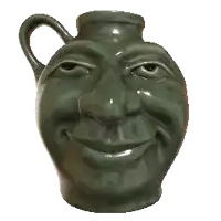 a green pitcher with a face on it is smiling