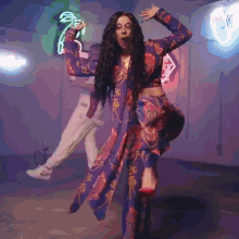 a woman with long hair is singing into a microphone in a room