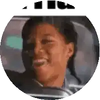 a woman is sitting in a car and smiling .