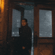 a man stands in front of a door that has the word exit on it