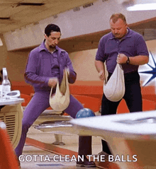two men are cleaning bowling balls in a bowling alley with the words gotta clean the balls below them .