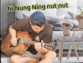a man is playing a guitar with the words ni nung ning nut nut written above him