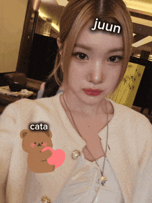 a girl with a sticker on her forehead that says juun and cata