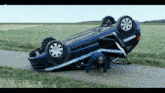 a man crawls under a car that has the word gendarmerie on it