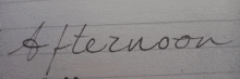the word afternoon is written in cursive on a piece of white paper