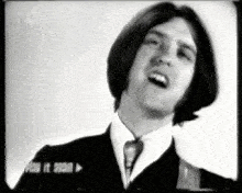 a black and white photo of a man in a suit and tie with a n3 logo in the corner