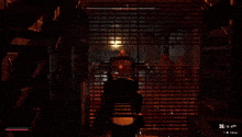 a person is playing a video game in a dark room with a gun .