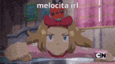 a cartoon of a girl with a pokemon on her head and the words melocita irl below her