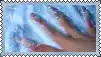 a close up of a person 's hand with long nails covered in soap .