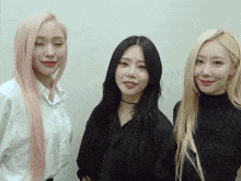 three women are standing next to each other with one wearing a choker