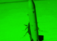 a green background with a rocket flying through the air