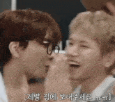 a couple of men are laughing and kissing each other . one of the men is wearing glasses .