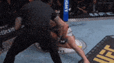 a referee in a boxing ring with a sign that says light
