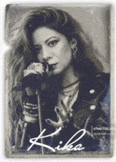 a black and white photo of a woman singing into a microphone with the name kika on the bottom