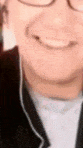 a close up of a person 's face with glasses and headphones