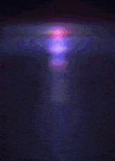 a purple and pink glowing object is floating in the dark
