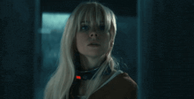 a woman wearing a collar with a red button on it