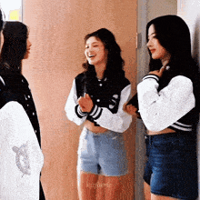 three girls are standing next to each other in a hallway and the name nisfaerie is on the bottom of the image