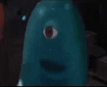 a blue object with a red eye and a mouth