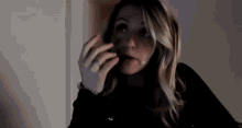 a woman with a ring on her finger looks up