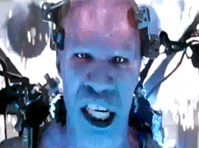 a close up of a man 's face with a few wires around his head