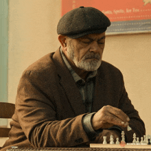 a man playing a game of chess with a sony music logo in the background